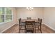 Bright dining room featuring a window and wooden table with seating for four at 303 Hamlet Rd, Summerville, SC 29485