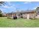 A house with a brick siding with a beautiful, expansive green backyard and a screened-in porch at 305 Driver Ave, Summerville, SC 29483