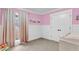 Light-filled bedroom with pink walls, white wainscoting, and a large window at 305 Driver Ave, Summerville, SC 29483