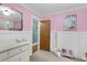 Bright bedroom featuring pink walls, white trim, and a wood door at 305 Driver Ave, Summerville, SC 29483