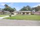 Charming single-story home with a well-manicured lawn, brick accents, and a convenient attached garage at 305 Driver Ave, Summerville, SC 29483