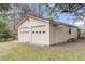 A detached two-car garage, with natural light and surrounded by greenery and a concrete pad at 305 Driver Ave, Summerville, SC 29483