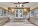 Sunroom with brick walls, vinyl floor, and double doors to the backyard at 305 Driver Ave, Summerville, SC 29483