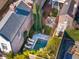 An aerial view of a brick home shows a backyard pool, lounge chairs, and outdoor dining area at 31 Hasell St, Charleston, SC 29401