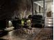 Backyard features a patio dining set, manicured hedges, and stairs leading to the porch at 31 Hasell St, Charleston, SC 29401