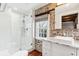 Modern bathroom with glass shower, brick accent wall, and sleek white vanity at 31 Hasell St, Charleston, SC 29401