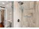 Stylish shower with gray tiling and a view into the vanity area at 31 Hasell St, Charleston, SC 29401