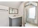 Clean and simple bathroom with a gray vanity and glass-enclosed shower at 31 Hasell St, Charleston, SC 29401