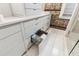 Bathroom vanity with sleek white cabinets, ample counter space, and a glimpse of the glass shower at 31 Hasell St, Charleston, SC 29401