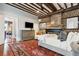 Spacious bedroom with exposed brick and beams, a plush rug, fireplace, and views to the sitting room at 31 Hasell St, Charleston, SC 29401