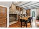 Rustic dining room features exposed brick, unique dining table, and ample storage for wine at 31 Hasell St, Charleston, SC 29401