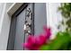 Close-up of the front door with a knocker and address number, hinting at charm at 31 Hasell St, Charleston, SC 29401