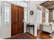 Bright entryway with wood door, sidelights, a side table, and hardwood floors at 31 Hasell St, Charleston, SC 29401