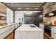 Open kitchen design featuring a large center island, modern lighting, and sleek, flat panel cabinets at 31 Hasell St, Charleston, SC 29401