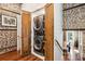 Modern laundry room with a stacked washer and dryer and exposed brick accent wall at 31 Hasell St, Charleston, SC 29401