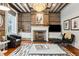 Inviting living room showcasing exposed brick, fireplace, and comfortable seating, perfect for relaxing or entertaining at 31 Hasell St, Charleston, SC 29401