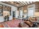 Comfortable living room with exposed beams, a rug, and custom shelving at 31 Hasell St, Charleston, SC 29401