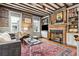 Inviting living room with a fireplace, bookshelves, and exposed beams at 31 Hasell St, Charleston, SC 29401
