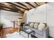 Cozy living room features exposed brick wall, hardwood floors, and a comfortable gray sofa at 31 Hasell St, Charleston, SC 29401