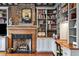 Cozy living room area with a fireplace, a desk area and custom shelving at 31 Hasell St, Charleston, SC 29401