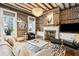 Cozy living room with exposed brick, fireplace, chandelier and comfortable seating at 31 Hasell St, Charleston, SC 29401