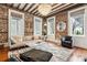 Elegant living room with exposed brick, hardwood floors, and stylish chandelier for a modern aesthetic at 31 Hasell St, Charleston, SC 29401