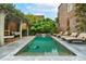 Beautiful backyard pool featuring a pergola, lounge chairs, and mature plants at 31 Hasell St, Charleston, SC 29401