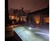 Evening view of the backyard and sparkling pool highlighting the brick perimeter walls and lush greenery at 31 Hasell St, Charleston, SC 29401
