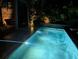 Beautiful outdoor pool area with brick and manicured foliage offers a private retreat at 31 Hasell St, Charleston, SC 29401