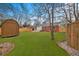 Backyard features a storage shed, a newly installed fence, a brick house and a well manicured lawn at 312 Mary Scott Dr, Goose Creek, SC 29445