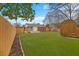 Backyard features a storage shed, a newly installed fence, a brick house and a well manicured lawn at 312 Mary Scott Dr, Goose Creek, SC 29445