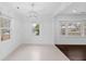 Bright dining room with crown molding, decorative chandelier, and large windows for natural light at 312 Mary Scott Dr, Goose Creek, SC 29445