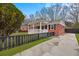 Well-maintained brick home featuring a covered porch and black fenced yard at 312 Mary Scott Dr, Goose Creek, SC 29445