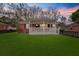 Charming red brick home with a inviting front porch and a well-manicured green lawn at 312 Mary Scott Dr, Goose Creek, SC 29445