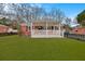 Charming red brick home with a inviting front porch and a well-manicured green lawn at 312 Mary Scott Dr, Goose Creek, SC 29445