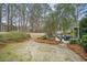 Spacious backyard features mature trees, stone patio, and outdoor seating at 3216 Rose Walk Ct, Mount Pleasant, SC 29466