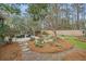 Backyard features a rock water feature, outdoor fireplace, landscaping and patio at 3216 Rose Walk Ct, Mount Pleasant, SC 29466
