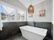 Bright and airy bathroom featuring freestanding tub, black hardware, and natural light at 3216 Rose Walk Ct, Mount Pleasant, SC 29466