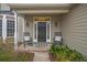 Inviting front porch with rocking chairs and a black front door at 3216 Rose Walk Ct, Mount Pleasant, SC 29466
