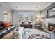 Cozy living room featuring a fireplace, large windows, and hardwood floors at 3216 Rose Walk Ct, Mount Pleasant, SC 29466