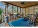 Inviting screened porch featuring comfortable seating and wood ceiling with ceiling fan at 3216 Rose Walk Ct, Mount Pleasant, SC 29466