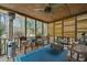 Inviting screened porch featuring comfortable seating and wood ceiling with ceiling fan at 3216 Rose Walk Ct, Mount Pleasant, SC 29466