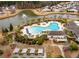 Attractive aerial view of a community pool, spa, and nearby lake with fountain at 323 Waterlily Way, Summerville, SC 29486