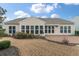Back exterior featuring a brick patio, large windows, and an awning for shade and outdoor living at 323 Waterlily Way, Summerville, SC 29486