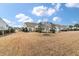 Wide-open backyard featuring beautiful houses and beautiful blue skies at 323 Waterlily Way, Summerville, SC 29486