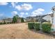 Large backyard with manicured bushes, expansive lawn, and private outdoor space at 323 Waterlily Way, Summerville, SC 29486
