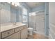 Bright bathroom with a shower, vanity, and a large mirror at 323 Waterlily Way, Summerville, SC 29486