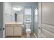 Bright bathroom with a shower, vanity, and a large mirror at 323 Waterlily Way, Summerville, SC 29486