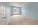 Light blue carpeted bedroom with large window letting in plenty of natural light at 323 Waterlily Way, Summerville, SC 29486