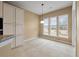 Bright breakfast nook featuring tiled floor, pendant light, and multiple windows with backyard views at 323 Waterlily Way, Summerville, SC 29486